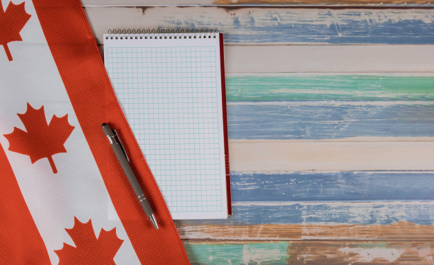 happy-victoria-day-canadian-flags-notepad-with-pen-rustic-background_73110-6244