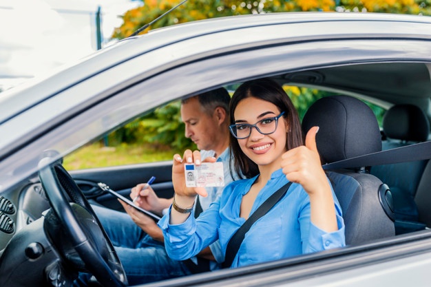 driving-school-beautiful-young-woman-successfully-passed-driving-school-test-she-looking_1391-2391