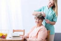senior-caretaker-combing-hair