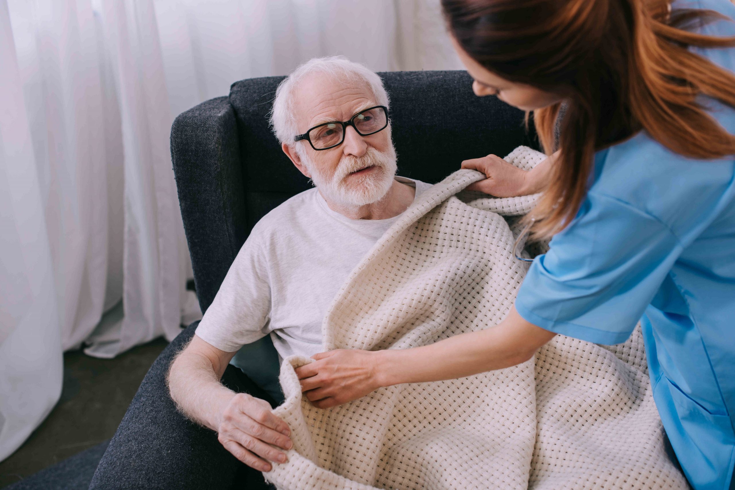 caregiver-covering-senior-patien